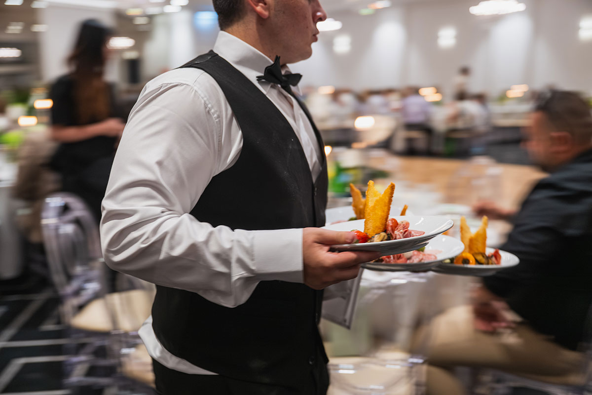 Waiter carrying food in Classic Ballroom at Conca D'oro wedding