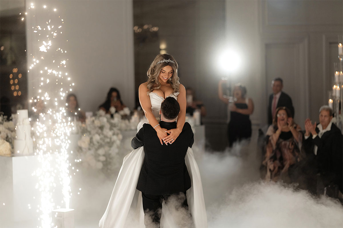 Happy bride and groom dancing in the Classic Ballroom at Conca D'oro