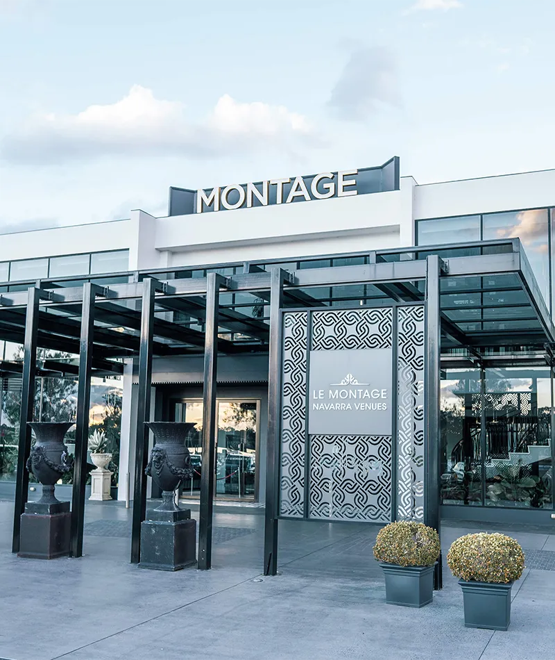 Earlier view of Le Montage’s entrance, with a light-coloured façade, glass canopy and rooftop Montage signage