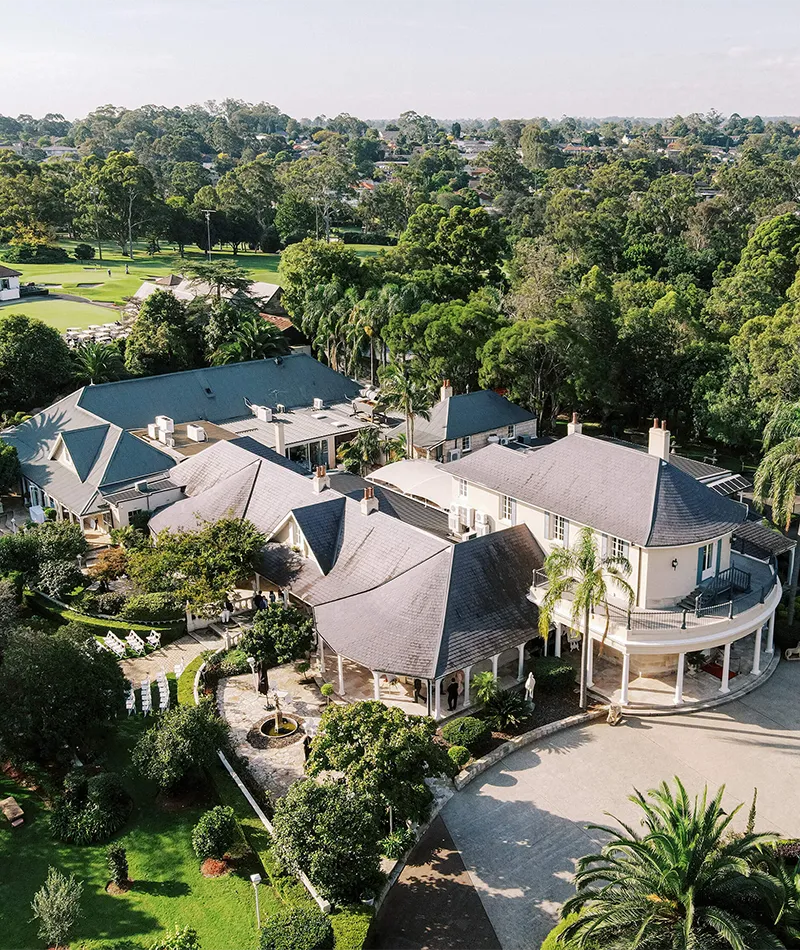 Aerial view of Oatlands Estate’s buildings and landscaped gardens surrounded by mature trees