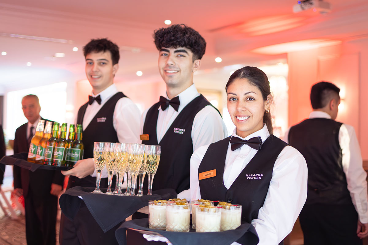 Navarra Venues staff smiling with trays and beverages