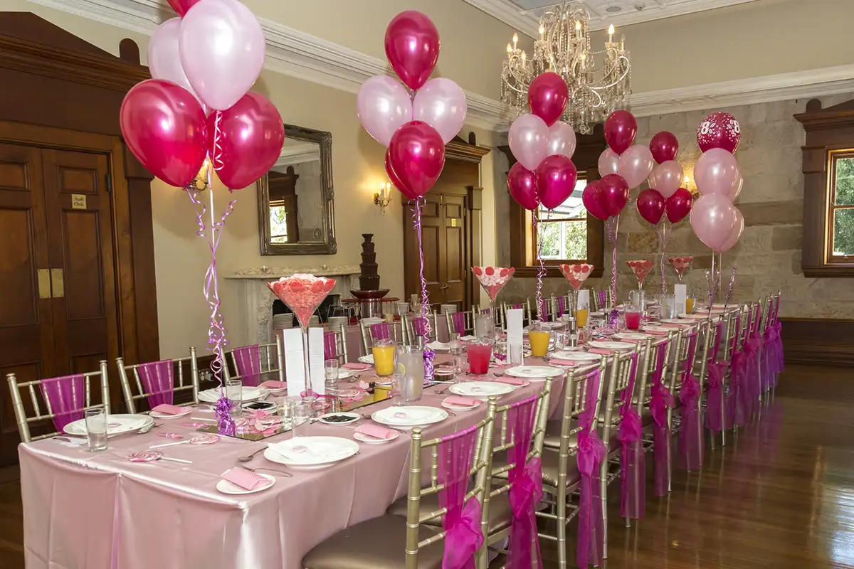 Kids' party table setting with pink balloons and decorations at Curzon Hall